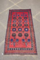 A vintage Persian Hamadan village rug with a unique design and colours on a red field, 140 x 256cm