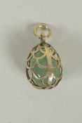 A Russian silver egg shaped pendant containing a green stone