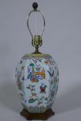 A Chinese porcelain table lamp with famille verte enamel decoration, on a wood base, 64cm high