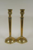A pair of Chinese brass hexagonal candlesticks with engraved floral decoration, 35cm high