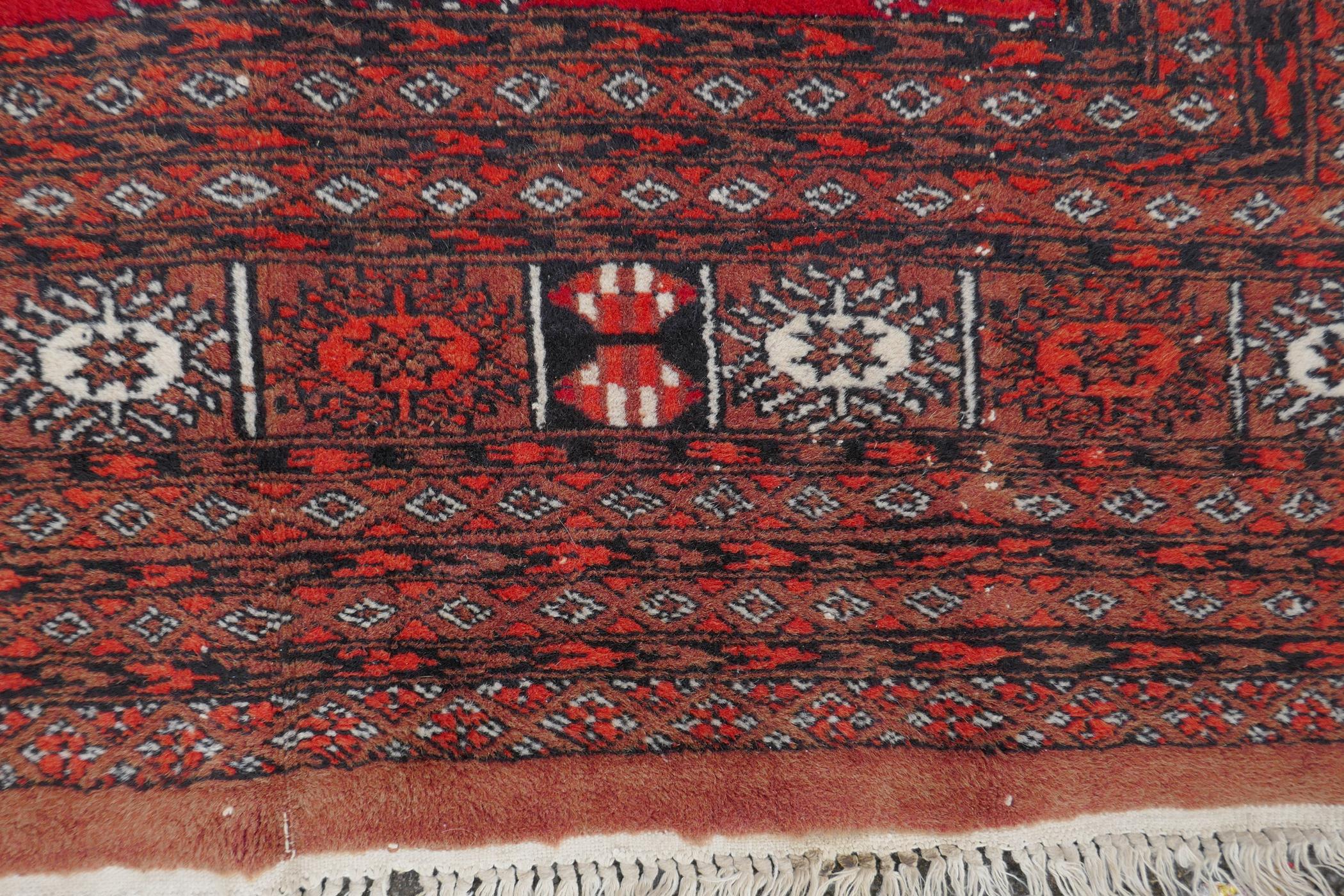 A red ground Bokhara rug with brown and orange borders, 128 x 175cm - Image 3 of 6