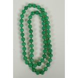 A string of apple green jade beads, 70cm