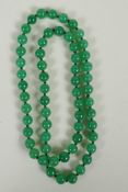 A string of apple green jade beads, 70cm