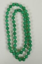 A string of apple green jade beads, 70cm