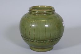 A Chinese green crackle glazed jar with ribbed decoration, 23cm high