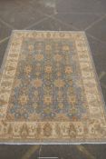 A Persian pewter ground Barouk Farahan carpet with an all over floral design and gold borders, 360 x