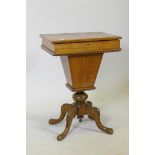 A Victorian inlaid walnut workbox, the rising top revealing a fitted interior, raised on carved