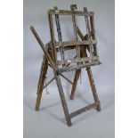 A well used wooden folding artist's easel, 62cm wide
