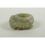 A Chinese carved celadon archers thumb ring, with kylin decoration, 5cm diameter