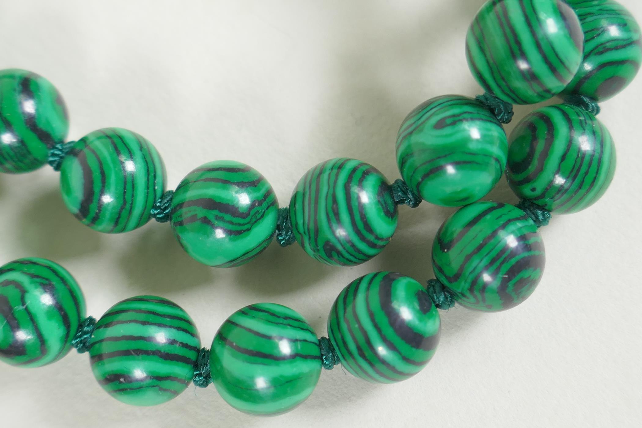 A string of tiger's eye beads, and a string of malachite style beads, longest 95cm - Image 3 of 3