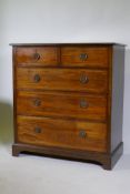 An inlaid mahogany chest of two over three drawers with brass ring handles, raised on a shaped