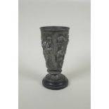 An antique French Grand Tour pewter goblet on a slate socle, with raised Greco Roman figural