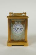 A miniature brass cased carriage clock with Sevres style porcelain panels, 6cm high