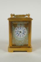 A miniature brass cased carriage clock with Sevres style porcelain panels, 6cm high