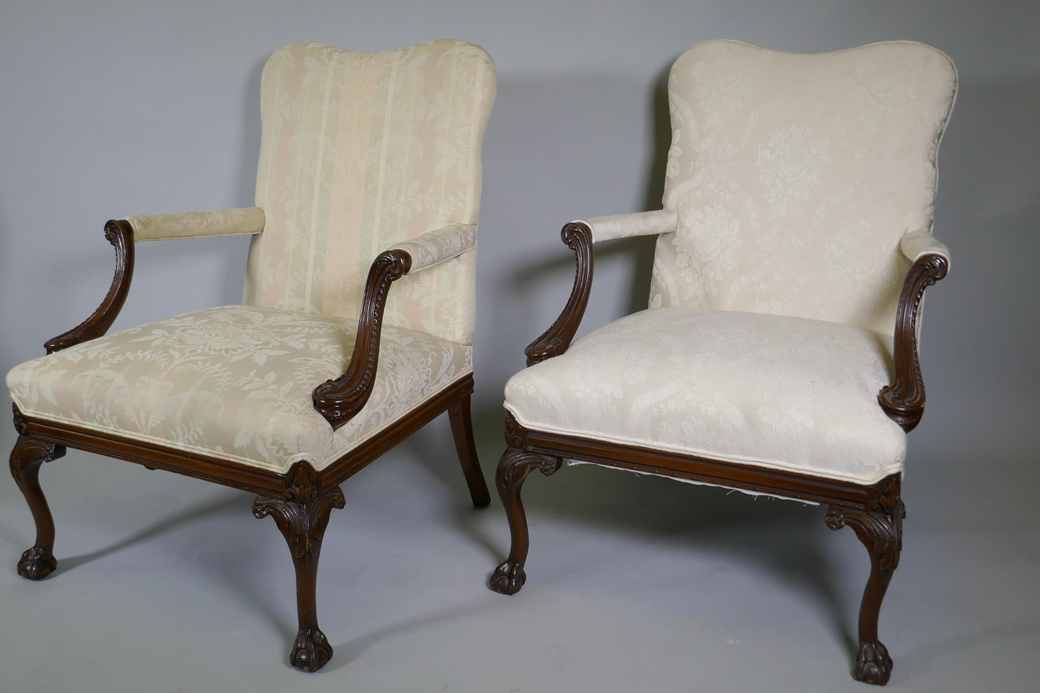 A pr of C18th style Gainsborough chairs with carved decoration and hump backs, raised on cabriole