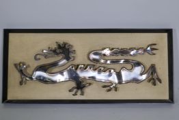 A mid-century stainless steel dragon, framed, labelled verso, Marler Haley Ltd, Barnet, Herts, 73