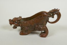 A Chinese bronze libation cup in the form of a kylin, 15cm long
