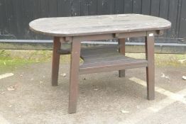 A varnished teak garden table with undertier, 137 x 70cm