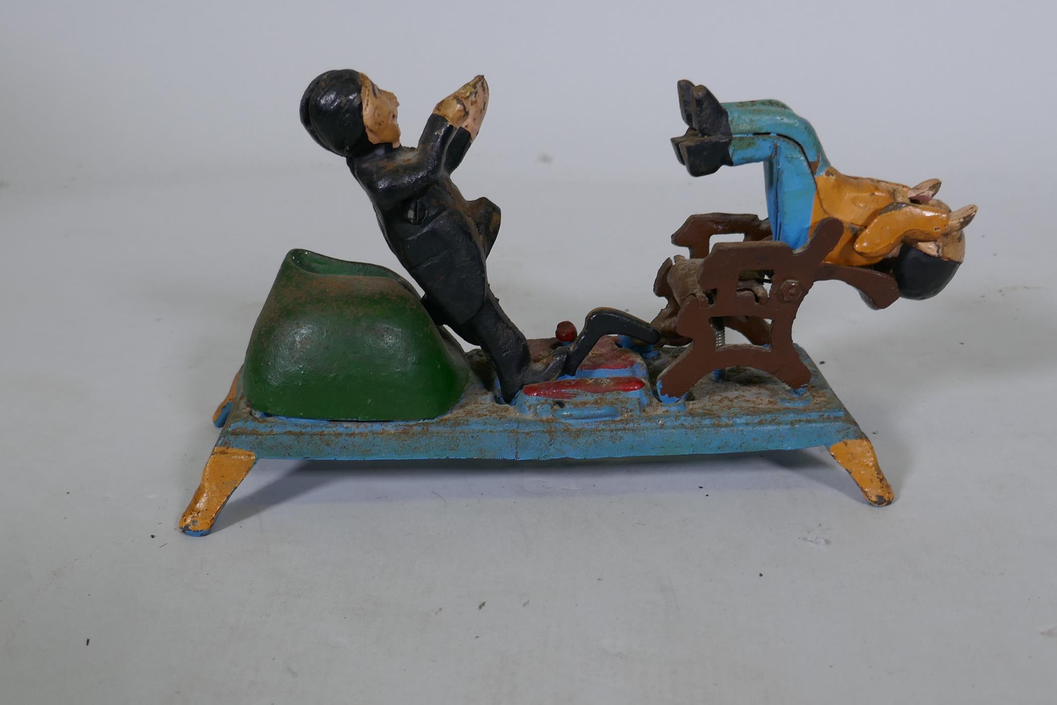 A painted cast iron money box in the form of a dentist, 22cm long, 16cm high - Image 3 of 3