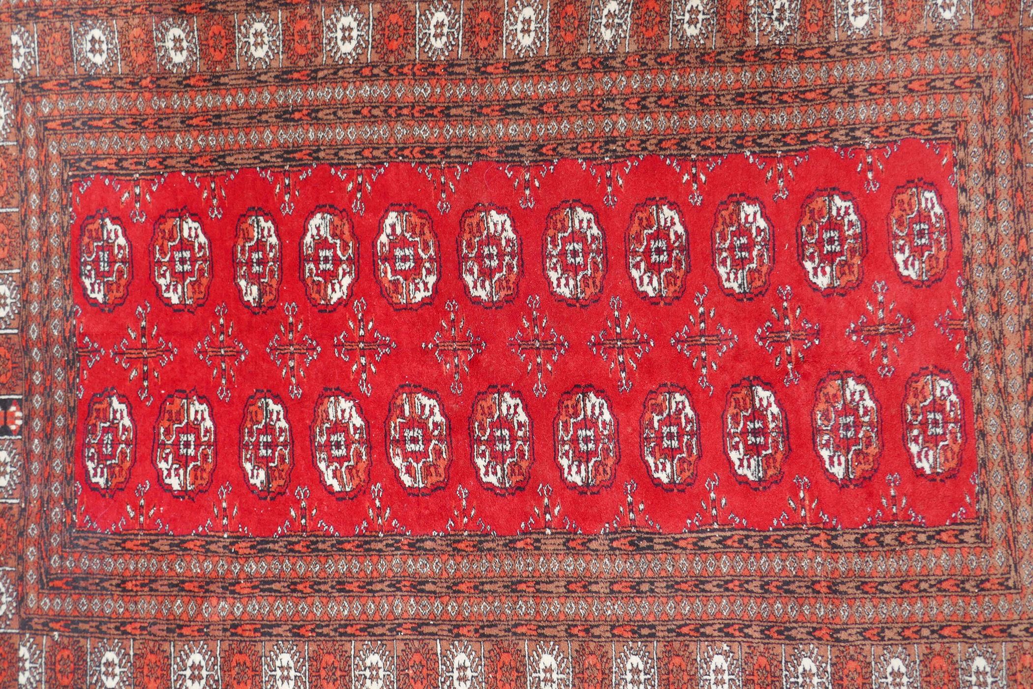 A red ground Bokhara rug with brown and orange borders, 128 x 175cm - Image 2 of 6