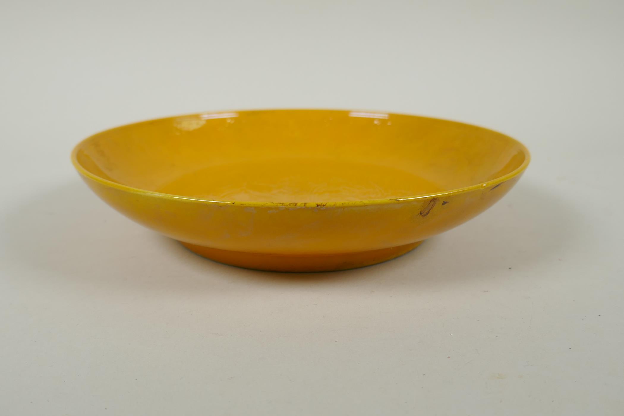 A Chinese yellow glazed porcelain dish with underglaze carp and lotus flower decoration, HongZhi 6 - Image 2 of 5
