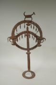 An Indian wrought iron oil lamp with animal decoration, 61cm high