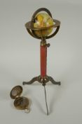 A brass and leather miniature terrestrial globe desk stand, and a replica brass compass, 27cm high