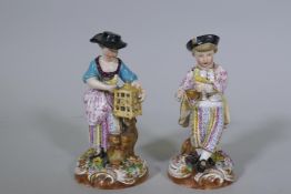 A pair of Continental hard paste porcelain figures, boy with a bird and a birdseller, factory mark