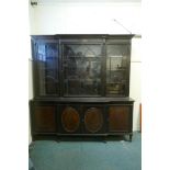 An Adam style mahogany breakfront bookcase, stamped Warings with a coronet, the cornice with