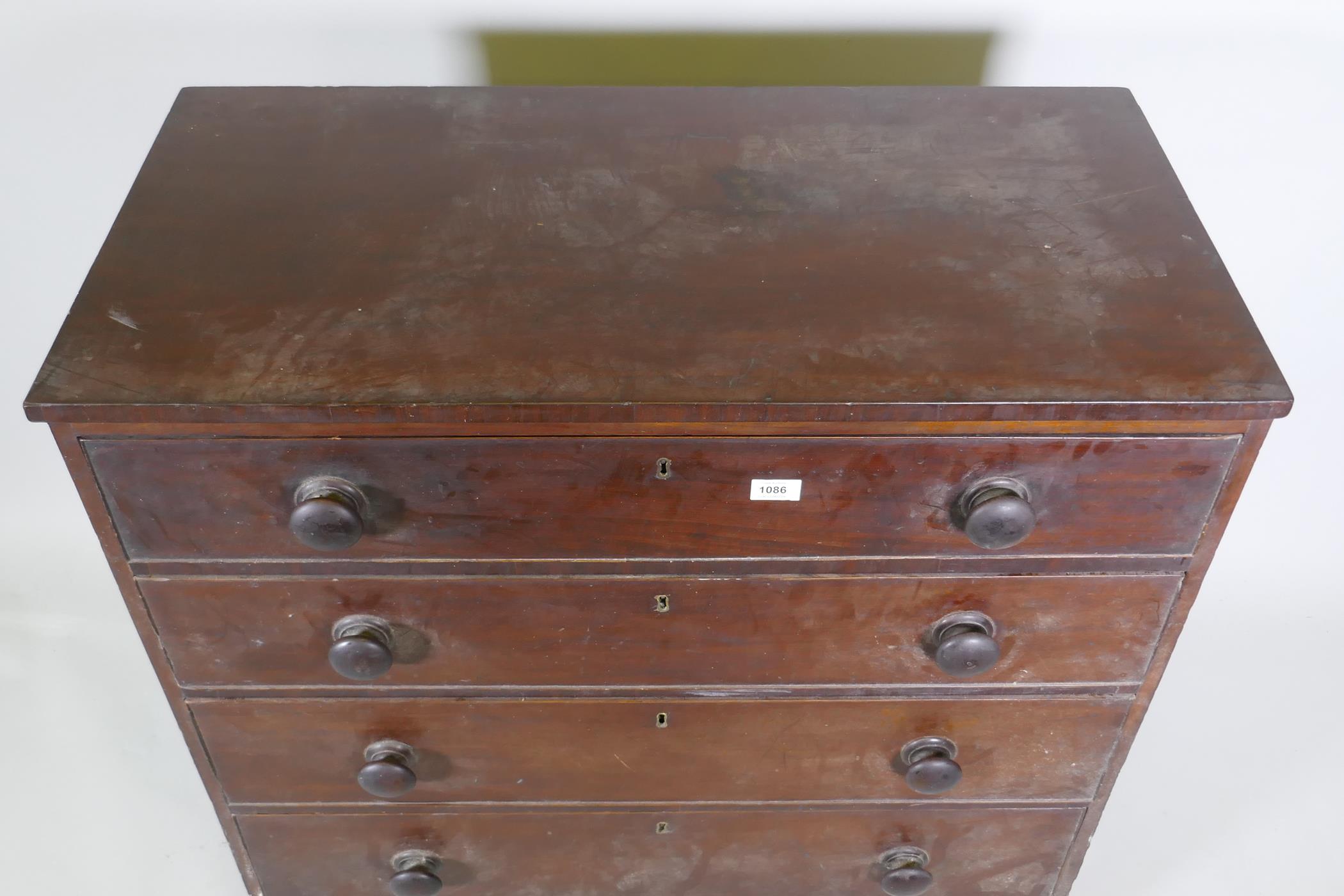 A Georgian mahogany chest of four long drawers, with cockbeaded detail and wooden knobs, raised on - Image 3 of 5