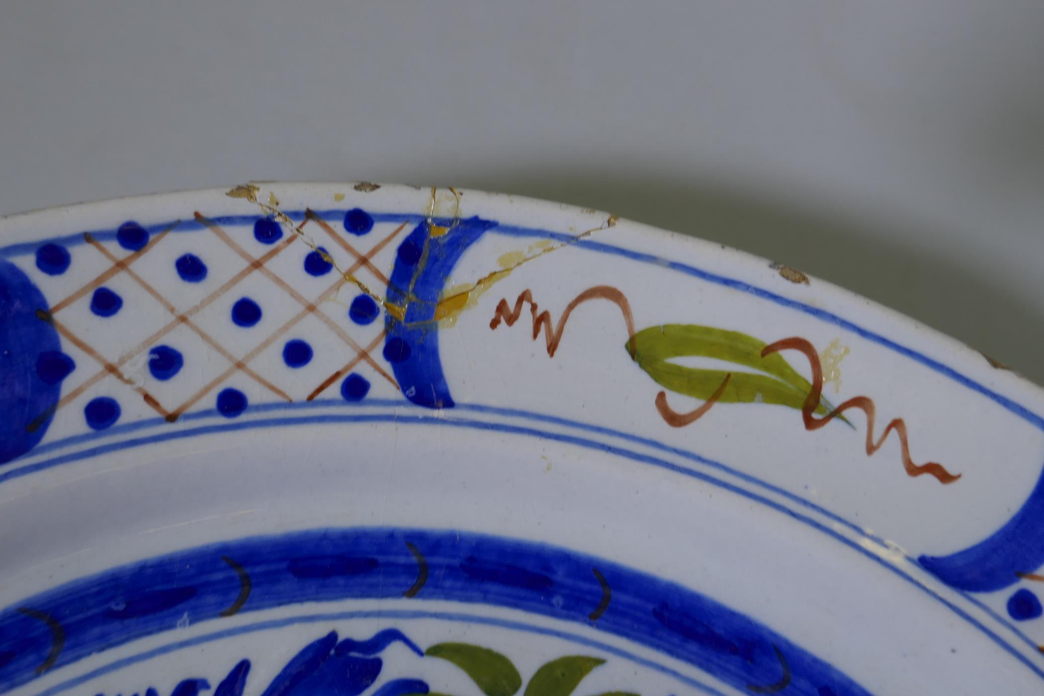 A Delft pottery charger with polychrome decoration of a vase and two birds, marked to base, Dutch - Image 5 of 5