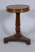 A C19th mahogany wine table, raised on Gillow style reeded column and platform base with bun