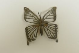 A Japanese style bronze okimono butterfly with articulated wings, 7cm