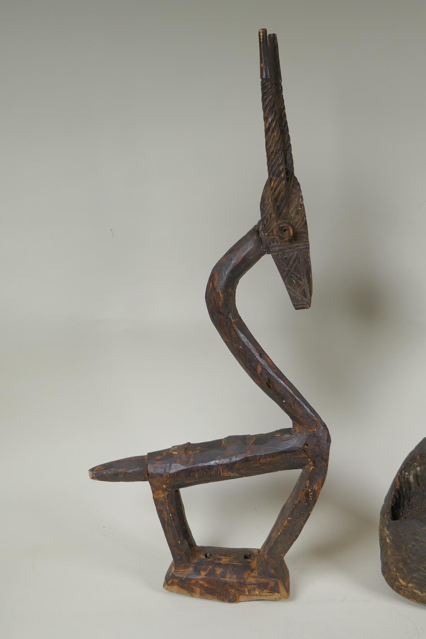 An African Bamana tribe carved wood Chi Wara antelope, together with a carved wood figure with - Image 2 of 4