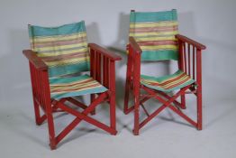 A pair of vintage campaign style folding deckchairs