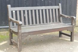A varnished teak garden bench, 150cm wide