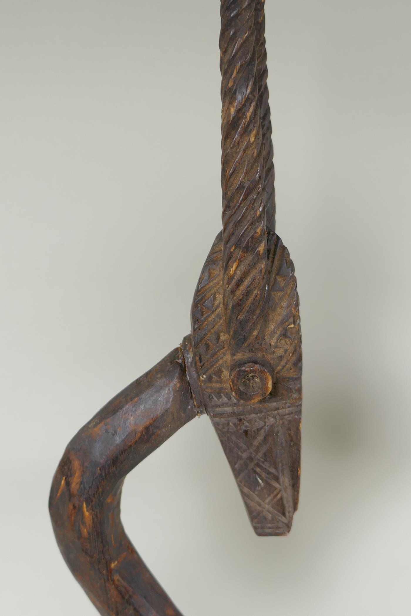 An African Bamana tribe carved wood Chi Wara antelope, together with a carved wood figure with - Image 3 of 4