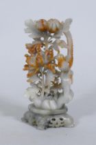 A Chinese carved soapstone ornament, depicting a bird with chrysanthemums, 19cm high