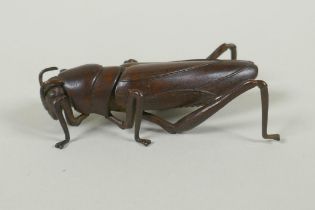 A Japanese style bronze okimono grasshopper, with articulated limbs, 8cm long