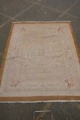 An antique French beige ground wool Savonnerie rug, 242 x 296cm