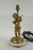 A gilt plated metal figural table lamp of a child playing a flute, in the manner of Auguste