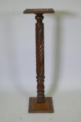 An antique Anglo Indian hardwood torchere with carved spiral leaf decoration to the column, 110cm