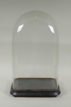 An antique glass clock dome and stand, 30 x 18cm, 47cm high