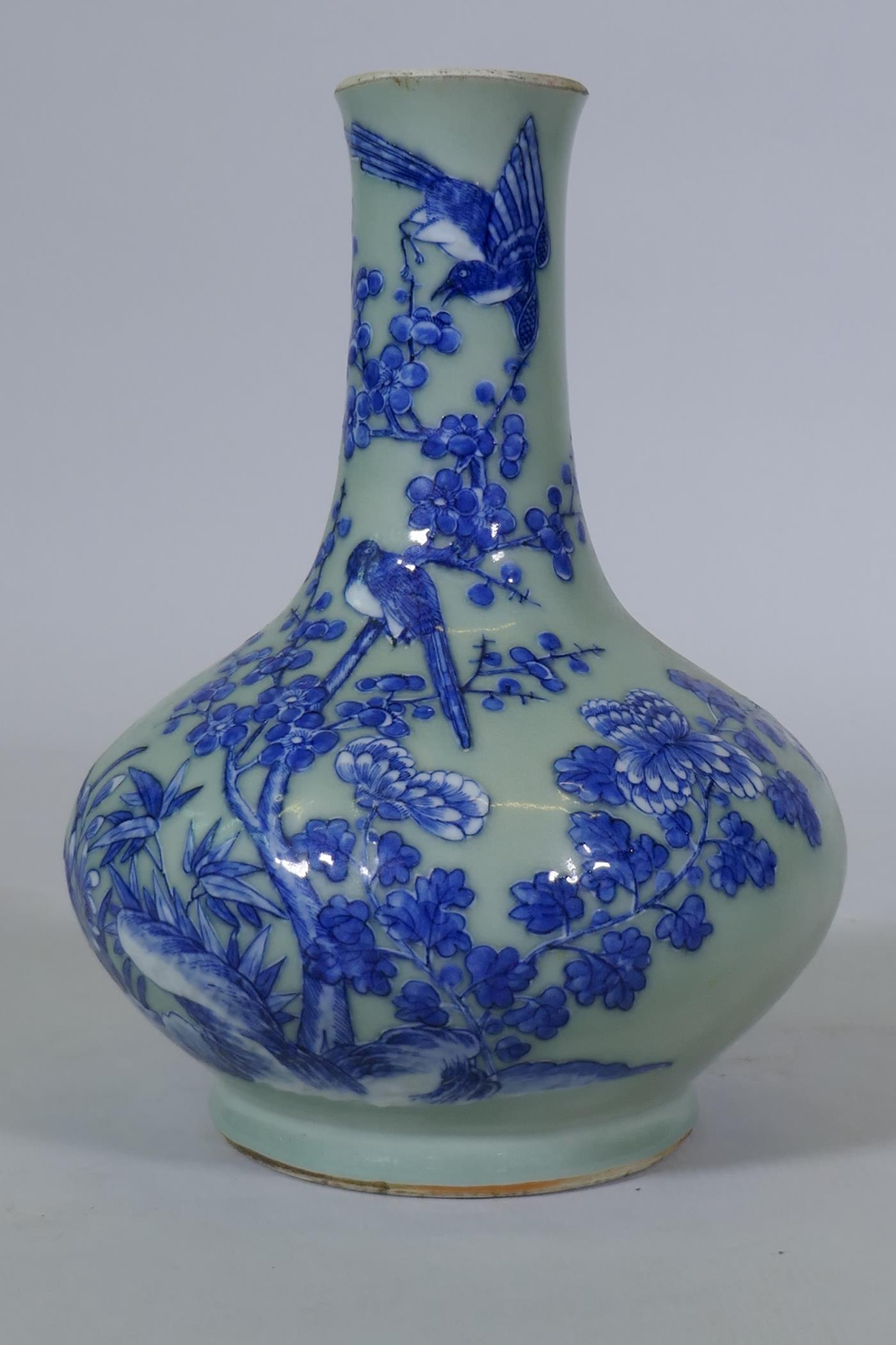 A Chinese celadon glazed vase with raised blue and white decoration of birds and bats, C19th/