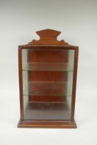 A mahogany desk top display cabinet, and a smaller display case, largest 31 x 29cm, 50cm high