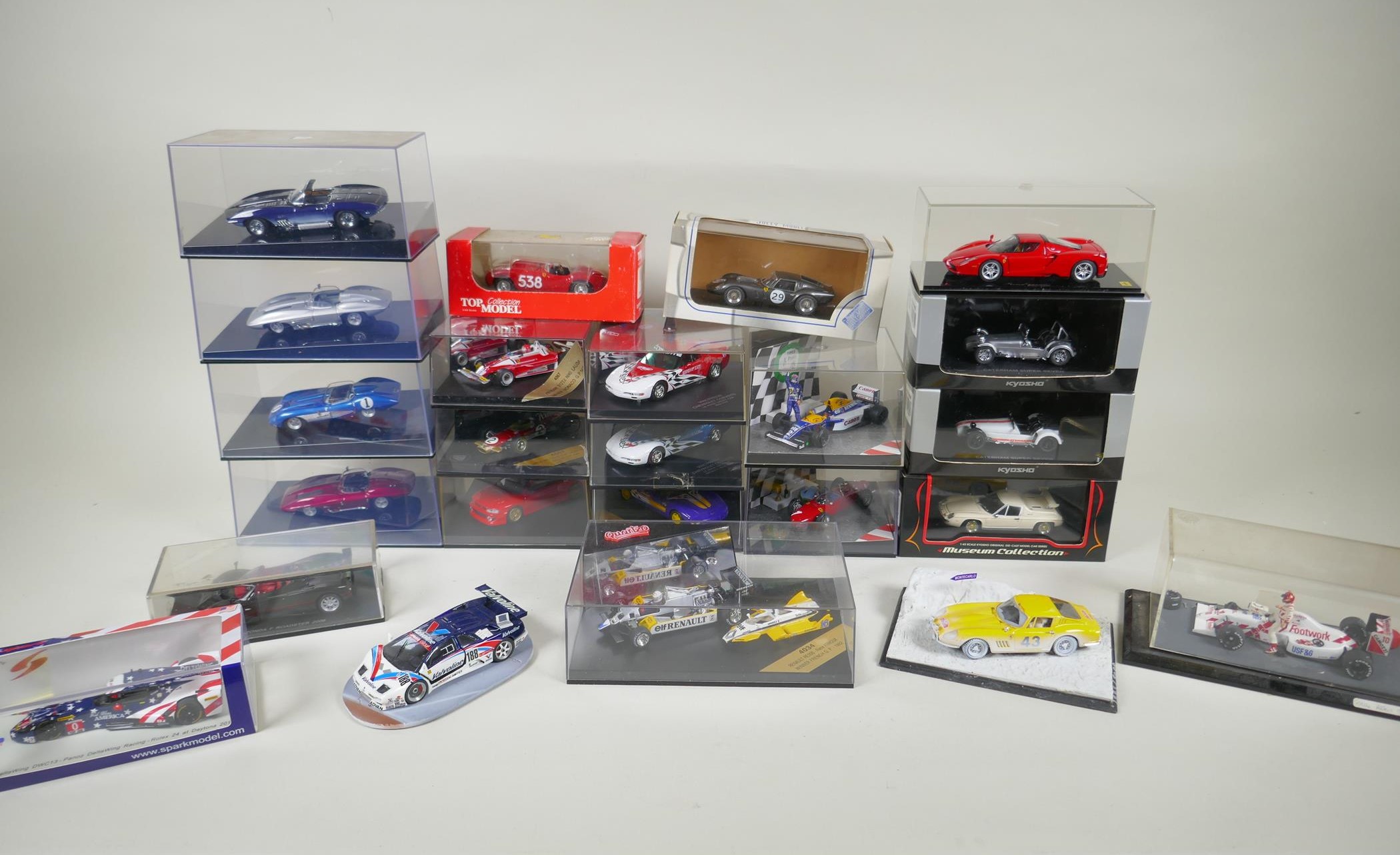 Twenty four 1:43 scale die cast model cars by various manufacturers including Auto Art, Spark,