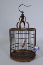 A Chinese wood bird cage with inset decoration, 68cm high