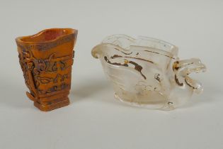 A Chinese moulded glass libation cup in the form of a phoenix, and a carved bone libation cup with