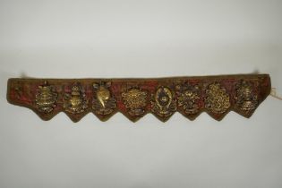 A Tibetan silk and linen belt with bronze mounts depicting the eight Buddhist treasures, 72cm long