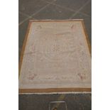 An antique French beige ground wool Savonnerie rug, 242 x 296cm